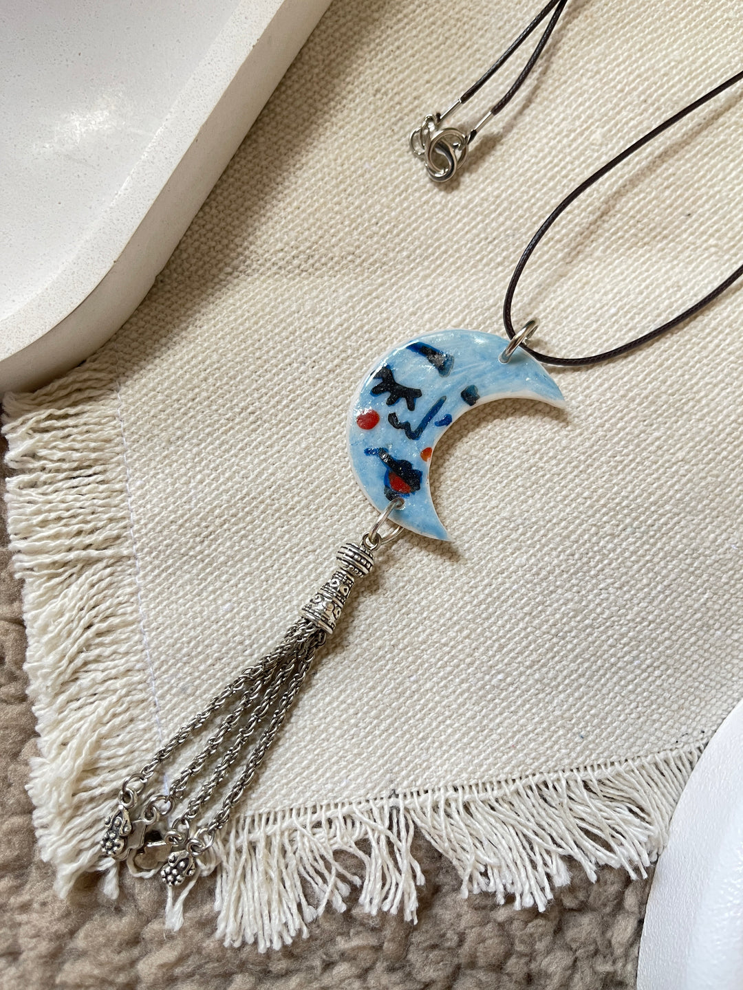 The moon face in blue necklace