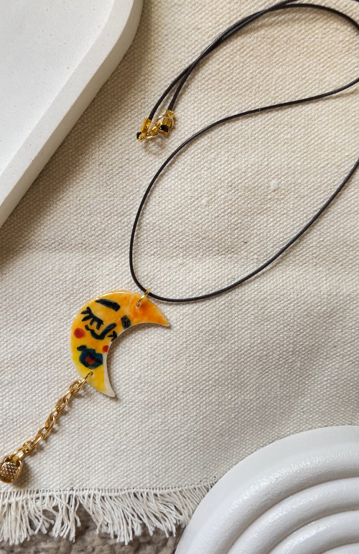 The moon face in yellow necklace